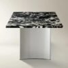 Dining table with black marble top and stainless steel base